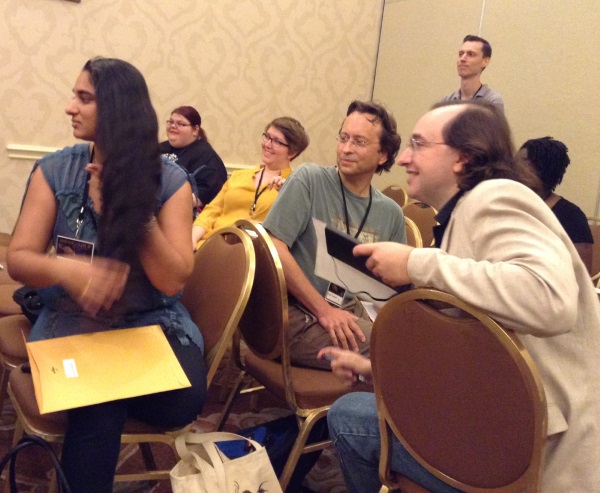 ArmadilloCon 2015 writers' workshop students Vidya, Roger, James (front) and others at the writing game.