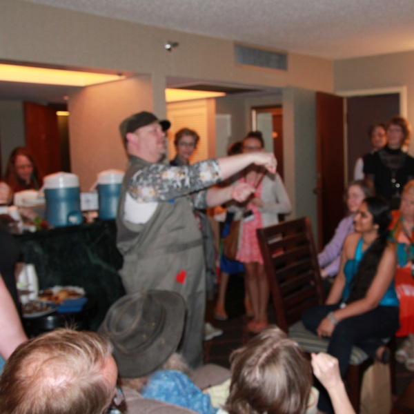 Teapunk Teas demonstrate tea duelling. It's a game of chicken played with tea-soaked biscuits. The two opponents hold up their soggy biscuits as shown, and stare each other down.